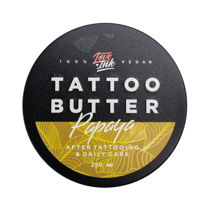 Close-up of a 250ml jar of Tattoo Butter Papaya by LoveInk. The product features a black and yellow design, emphasizing its use for after tattooing and daily care.