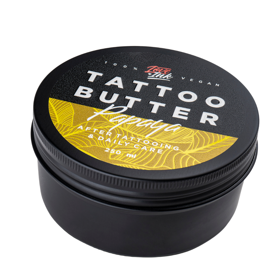 Close-up of a 250ml jar of Tattoo Butter Papaya by LoveInk. The product features a black and yellow design, emphasizing its use for after tattooing and daily care.
