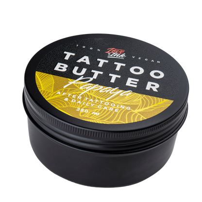 Close-up of a 250ml jar of Tattoo Butter Papaya by LoveInk. The product features a black and yellow design, emphasizing its use for after tattooing and daily care.