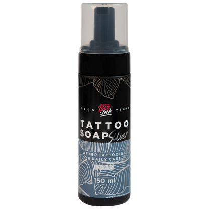 Image of LoveInk's Tattoo Soap Silver bottle containing 150ml of foam for tattoo care. The black bottle features white and silver botanical designs with a clear cap.